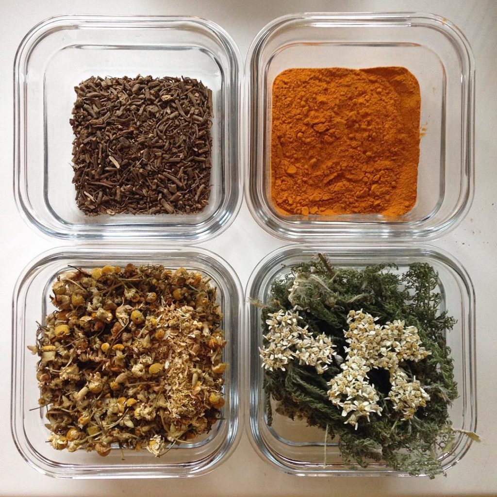 Valerian root, turmeric powder, chamomile flowers, and yarrow leaves and flowers, ready to be added to Salve Ale.
