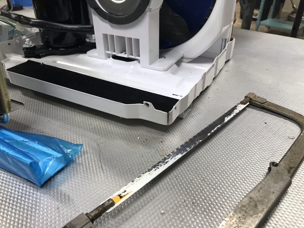 Modifying the A/C base plate with a hacksaw